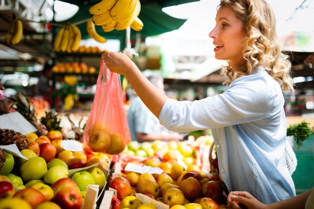 A woman buying fruits at the local shop

